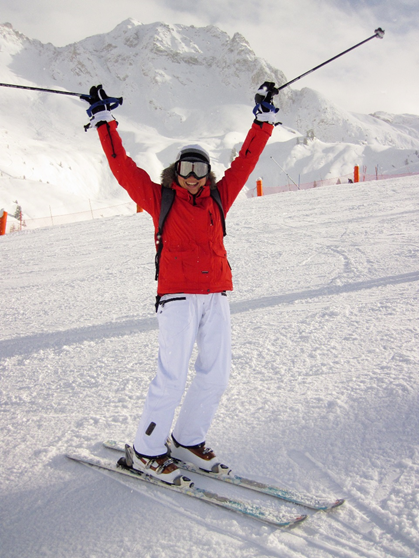 Skier holding ski poles up in the air